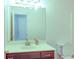 Bathroom with a large mirror, a white sink, a dark vanity, and a toilet at 2423 Walnut Tree Ln, Buford, GA 30519