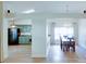 Open-concept dining room with wood floors, modern lighting, and easy access to kitchen at 2423 Walnut Tree Ln, Buford, GA 30519