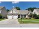 Charming single Gathering home with a well-manicured lawn and a two-car garage at 2423 Walnut Tree Ln, Buford, GA 30519