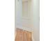 Neutral hallway with wood-style flooring and white trim at 2423 Walnut Tree Ln, Buford, GA 30519