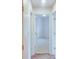 Bright hallway with hardwood floors leading to a bedroom with neutral carpet at 2423 Walnut Tree Ln, Buford, GA 30519
