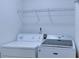 Laundry room equipped with a washer, dryer and shelving, offering practicality at 2423 Walnut Tree Ln, Buford, GA 30519