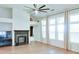 Bright living room featuring vaulted ceilings, fireplace, large windows, and wood floors at 2423 Walnut Tree Ln, Buford, GA 30519