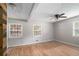 Bedroom featuring hardwood floors, three windows, and a ceiling fan at 60 Newton Ridge Dr, Covington, GA 30014