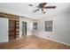 Spacious bedroom featuring hardwood floors, a ceiling fan, and a closet with a rustic wood accent wall at 60 Newton Ridge Dr, Covington, GA 30014