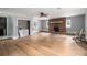 Spacious living room featuring hardwood floors, a brick fireplace, and ample natural light at 60 Newton Ridge Dr, Covington, GA 30014