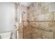 Accessible shower with a shower seat and grab bars, featuring stylish tile surround and glass door at 60 Newton Ridge Dr, Covington, GA 30014