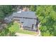 Aerial view of a home showcasing a screened-in porch, back deck and large backyard with swimming pool at 10560 Haynes Bridge Rd, Alpharetta, GA 30022
