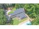 Aerial view of a home showcasing a screened-in porch, back deck and large backyard with swimming pool at 10560 Haynes Bridge Rd, Alpharetta, GA 30022