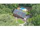 Expansive aerial view of a brick home with a private backyard oasis, including a sparkling pool at 10560 Haynes Bridge Rd, Alpharetta, GA 30022