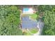 Stunning aerial view of a home with a pool surrounded by lush trees at 10560 Haynes Bridge Rd, Alpharetta, GA 30022