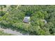 Aerial perspective showcasing a home with a pool, surrounded by a dense canopy of trees at 10560 Haynes Bridge Rd, Alpharetta, GA 30022