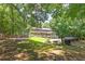 Expansive backyard featuring a refreshing swimming pool, firepit area, and lush landscaping at 10560 Haynes Bridge Rd, Alpharetta, GA 30022