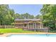 Expansive backyard featuring a refreshing swimming pool, screened porch, and well-maintained lawn at 10560 Haynes Bridge Rd, Alpharetta, GA 30022