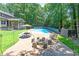 Inviting backyard with a sparkling swimming pool, firepit area, and ample seating for outdoor enjoyment at 10560 Haynes Bridge Rd, Alpharetta, GA 30022