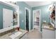 Bathroom featuring double sinks with granite countertops and a vanity with framed mirror at 10560 Haynes Bridge Rd, Alpharetta, GA 30022