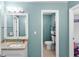 Bright bathroom featuring a vanity with granite counters and a separate toilet room at 10560 Haynes Bridge Rd, Alpharetta, GA 30022