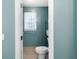 Bathroom features a toilet, window, and towel rack for a functional and bright space at 10560 Haynes Bridge Rd, Alpharetta, GA 30022
