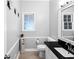 Cozy bathroom with black granite countertop, vanity, and storage at 10560 Haynes Bridge Rd, Alpharetta, GA 30022