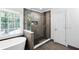 Modern bathroom with glass shower and soaking tub, offering a spa-like experience at 10560 Haynes Bridge Rd, Alpharetta, GA 30022
