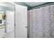 Bright bathroom featuring a granite-topped vanity and a floral shower curtain at 10560 Haynes Bridge Rd, Alpharetta, GA 30022