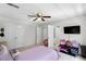 Bright bedroom with a ceiling fan, flat-screen TV, and white trim at 10560 Haynes Bridge Rd, Alpharetta, GA 30022