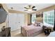 Cozy bedroom features plush bed, ceiling fan and large closet for ample storage at 10560 Haynes Bridge Rd, Alpharetta, GA 30022