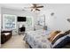 Well-lit bedroom with two windows, comfortable seating, and a ceiling fan at 10560 Haynes Bridge Rd, Alpharetta, GA 30022