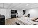 Finished basement bedroom with a large TV and neutral decor at 10560 Haynes Bridge Rd, Alpharetta, GA 30022
