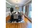 Formal dining room with hardwood floors, wainscoting, and decorative shuttered windows at 10560 Haynes Bridge Rd, Alpharetta, GA 30022