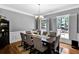 Formal dining room with hardwood floors, elegant chandelier, and large windows at 10560 Haynes Bridge Rd, Alpharetta, GA 30022