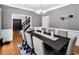 Well-lit dining room with a chandelier and wainscoting detail is ideal for Gathering gatherings at 10560 Haynes Bridge Rd, Alpharetta, GA 30022