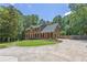 Two-story home with brick and vinyl siding and a long driveway in a wooded lot at 10560 Haynes Bridge Rd, Alpharetta, GA 30022