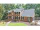 Charming two-story brick home with a manicured lawn and a welcoming entrance at 10560 Haynes Bridge Rd, Alpharetta, GA 30022