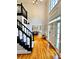 Bright foyer with high ceilings, hardwood floors, and elegant staircase with dark banister at 10560 Haynes Bridge Rd, Alpharetta, GA 30022