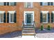 Brick home featuring a covered front door and manicured landscaping at 10560 Haynes Bridge Rd, Alpharetta, GA 30022