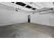 Bright two-car garage with white door and exterior door to the backyard at 10560 Haynes Bridge Rd, Alpharetta, GA 30022