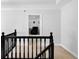 Neutral hallway with access to a room; black handrail; white walls at 10560 Haynes Bridge Rd, Alpharetta, GA 30022