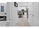 Hallway view to kitchen and secondary sink with storage at 10560 Haynes Bridge Rd, Alpharetta, GA 30022