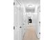 Bright hallway with neutral-toned carpet and white doors at 10560 Haynes Bridge Rd, Alpharetta, GA 30022