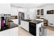 Modern kitchen with stainless steel appliances, a sink island, and stone countertops at 10560 Haynes Bridge Rd, Alpharetta, GA 30022