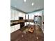Well-equipped kitchen featuring stainless steel appliances, granite countertops and white cabinets at 10560 Haynes Bridge Rd, Alpharetta, GA 30022