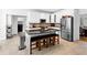 Spacious eat-in kitchen with stainless steel appliances and island seating at 10560 Haynes Bridge Rd, Alpharetta, GA 30022