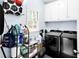 Laundry room with appliances and ample storage and modern washer/dryer at 10560 Haynes Bridge Rd, Alpharetta, GA 30022
