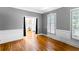 Elegant living room with hardwood floors, wainscoting, and large windows with shutters at 10560 Haynes Bridge Rd, Alpharetta, GA 30022