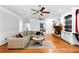 Spacious living room with a brick fireplace, plush seating, and hardwood floors at 10560 Haynes Bridge Rd, Alpharetta, GA 30022