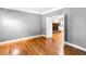 Open living room with hardwood floors offers seamless transition from room to room at 10560 Haynes Bridge Rd, Alpharetta, GA 30022