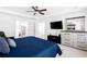 Well-lit primary bedroom with ensuite bathroom, and large dresser at 10560 Haynes Bridge Rd, Alpharetta, GA 30022