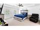 Large primary bedroom with tray ceilings, two large windows, and sitting area at 10560 Haynes Bridge Rd, Alpharetta, GA 30022