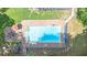 Clear, blue swimming pool with concrete surround, stairs, and an umbrella covered patio area at 10560 Haynes Bridge Rd, Alpharetta, GA 30022